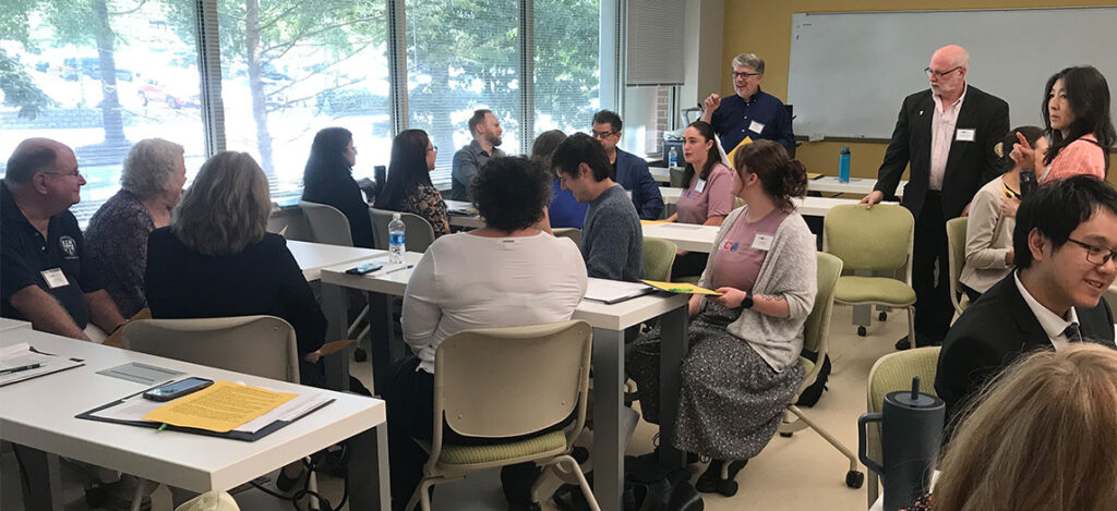 Dr. Christopher Poulos shows CCA attendees how to engage in "Democracy Tables."