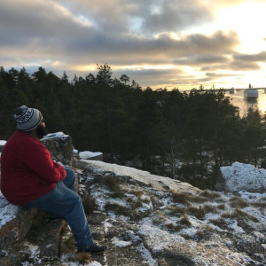 Chris Jordan sitting on rock in nature