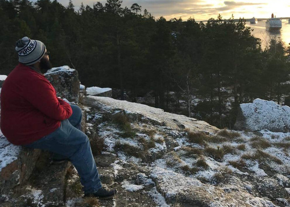 Chris Jordan sitting on rock in nature